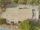 Top down view of a tan roof, partially obscured by trees, in a rural landscape with a nearby street at 4021 Jesse St, Pahrump, NV 89048