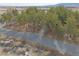 Scenic aerial view of a property surrounded by trees, desert landscape, and mountains at 4021 Jesse St, Pahrump, NV 89048
