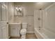 Bright bathroom featuring a vanity, toilet and a shower-tub combination with modern fixtures at 4021 Jesse St, Pahrump, NV 89048