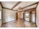 A cozy bedroom features unique brick flooring, a ceiling fan, and a spacious closet at 4021 Jesse St, Pahrump, NV 89048