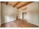 Bright bedroom features wood floors, vaulted ceilings, and a ceiling fan at 4021 Jesse St, Pahrump, NV 89048