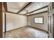 A rustic bedroom featuring brick floors, wood-beamed ceilings, and a ceiling fan at 4021 Jesse St, Pahrump, NV 89048