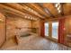 Bedroom featuring a jacuzzi tub, brick accents, wood paneling, and exposed wood beams at 4021 Jesse St, Pahrump, NV 89048