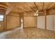 Spacious bedroom with brick floors, wood-paneled walls, a fan, and a skylight at 4021 Jesse St, Pahrump, NV 89048
