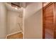 Walk in closet with wood flooring and exposed clothing rods at 4021 Jesse St, Pahrump, NV 89048
