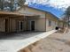 Side view of the home's exterior featuring a long driveway and multiple entrances at 4021 Jesse St, Pahrump, NV 89048
