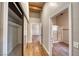 Bright hallway features wood floors, closet with mirrored doors, and leads to the bathroom at 4021 Jesse St, Pahrump, NV 89048