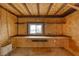 Unfinished room features wood ceiling beams, shelves, a window, and partial OSB walls at 4021 Jesse St, Pahrump, NV 89048