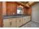 A cozy kitchenette has cream-colored cabinets, sleek countertops, and a window for natural light at 4021 Jesse St, Pahrump, NV 89048