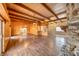 Open living room boasts wood paneling, beamed ceilings, and stone fireplace feature at 4021 Jesse St, Pahrump, NV 89048