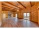 Expansive living room showcasing wood paneling, beamed ceilings, and a stone fireplace at 4021 Jesse St, Pahrump, NV 89048