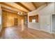 Bright living room showcasing wood-paneled walls, exposed beams, and a decorative light fixture at 4021 Jesse St, Pahrump, NV 89048