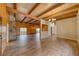 Inviting living room featuring wood-paneled walls, stone fireplace, and stylish flooring and ceiling at 4021 Jesse St, Pahrump, NV 89048