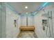 Modern shower with dual shower heads, a built in bench, and blue LED accent lighting at 4021 Jesse St, Pahrump, NV 89048