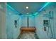 Modern shower with dual shower heads, a built in bench, and blue LED accent lighting at 4021 Jesse St, Pahrump, NV 89048