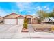 Inviting single-story home with desert landscaping, a tiled roof, and a two-car garage at 4318 Red Blanket Rd, North Las Vegas, NV 89032