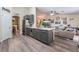 Modern kitchen with gray cabinets, stainless steel appliances, white countertops, and an open layout leading into the living room at 4318 Red Blanket Rd, North Las Vegas, NV 89032