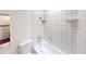Tiled bathroom featuring a toilet, sink, and bathtub with tiled walls at 4712 Primavera St, Las Vegas, NV 89122