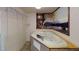 Relaxing bathroom features an oval soaking tub with beautiful mountain view wall art and nearby closet system at 4712 Primavera St, Las Vegas, NV 89122