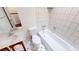 Tiled bathroom featuring a toilet, sink, and bathtub with tiled walls at 4712 Primavera St, Las Vegas, NV 89122