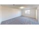Carpeted bedroom featuring a large window and bright natural light at 4712 Primavera St, Las Vegas, NV 89122