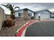 View of the single-story home's exterior, showcasing the yard and desert landscaping at 4712 Primavera St, Las Vegas, NV 89122