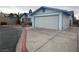 View of the home's side and two-car garage, showcasing its well-maintained exterior at 4712 Primavera St, Las Vegas, NV 89122