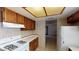 Functional kitchen layout with neutral tile backsplash, white appliances, and ample storage at 4712 Primavera St, Las Vegas, NV 89122