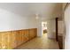 Bright living room with tile floors and wood-paneled wainscoting, adjacent to kitchen at 4712 Primavera St, Las Vegas, NV 89122