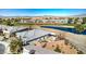 Aerial view of the property highlighting its proximity to a pond and lush green spaces at 4924 E Cactus Canyon Dr, Pahrump, NV 89061