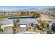 Beautiful aerial shot of the house showing landscaping, a three car garage, and proximity to the green at 4924 E Cactus Canyon Dr, Pahrump, NV 89061