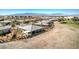 Expansive aerial view of a home backing to a golf course and featuring a covered patio area at 4924 E Cactus Canyon Dr, Pahrump, NV 89061