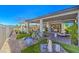 Lovely backyard with a covered patio, lush greenery, and a serene water feature at 4924 E Cactus Canyon Dr, Pahrump, NV 89061