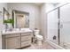Modern bathroom featuring a vanity with drawers and a tiled walk-in shower with glass doors at 4924 E Cactus Canyon Dr, Pahrump, NV 89061