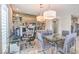 Stylish dining area with a glass table, modern lighting, and a custom bar area at 4924 E Cactus Canyon Dr, Pahrump, NV 89061