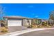 Desert home with gray exterior, desert landscaping, and a two-car garage at 4924 E Cactus Canyon Dr, Pahrump, NV 89061