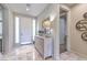 Inviting foyer with marble flooring, accent cabinet, decorative mirrors, and a view of the bathroom at 4924 E Cactus Canyon Dr, Pahrump, NV 89061