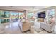 Bright living room with a comfortable sectional sofa, marble floors, and access to the patio at 4924 E Cactus Canyon Dr, Pahrump, NV 89061