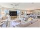 Bright, open living room featuring modern furnishings, a ceiling fan, and a well-stocked bar area at 4924 E Cactus Canyon Dr, Pahrump, NV 89061
