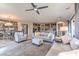 Spacious open-concept living area with stylish furnishings adjacent to dining and kitchen at 4924 E Cactus Canyon Dr, Pahrump, NV 89061
