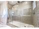 Modern glass-enclosed shower with mosaic tile and rainfall shower head at 4924 E Cactus Canyon Dr, Pahrump, NV 89061