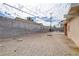 Large backyard featuring a concrete block wall, and an outdoor seating area at 5109 Sugarfoot Ave, Las Vegas, NV 89107