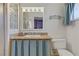 Bright bathroom features a granite countertop vanity, a shower with glass block, and blue decorative accents at 5109 Sugarfoot Ave, Las Vegas, NV 89107