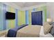 Bedroom featuring striped walls, a comfortable bed, and a mounted TV at 5109 Sugarfoot Ave, Las Vegas, NV 89107