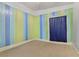 Bedroom with striped walls and a window covered by a blue curtain at 5109 Sugarfoot Ave, Las Vegas, NV 89107