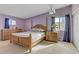 Cozy bedroom featuring a wooden bed frame, soft lighting, and ample closet space at 5109 Sugarfoot Ave, Las Vegas, NV 89107