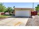 Single-story home featuring a well-manicured front yard, and a two-car garage at 5109 Sugarfoot Ave, Las Vegas, NV 89107