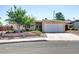 Well-kept single-story home featuring a lush front yard and a two-car garage at 5109 Sugarfoot Ave, Las Vegas, NV 89107