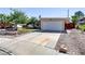 Single-story home with well-maintained landscaping, a long driveway, and a two-car garage at 5109 Sugarfoot Ave, Las Vegas, NV 89107