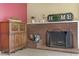 Close up view of fireplace with decor, brick surround, and adjacent hutch in a cozy living space at 5109 Sugarfoot Ave, Las Vegas, NV 89107